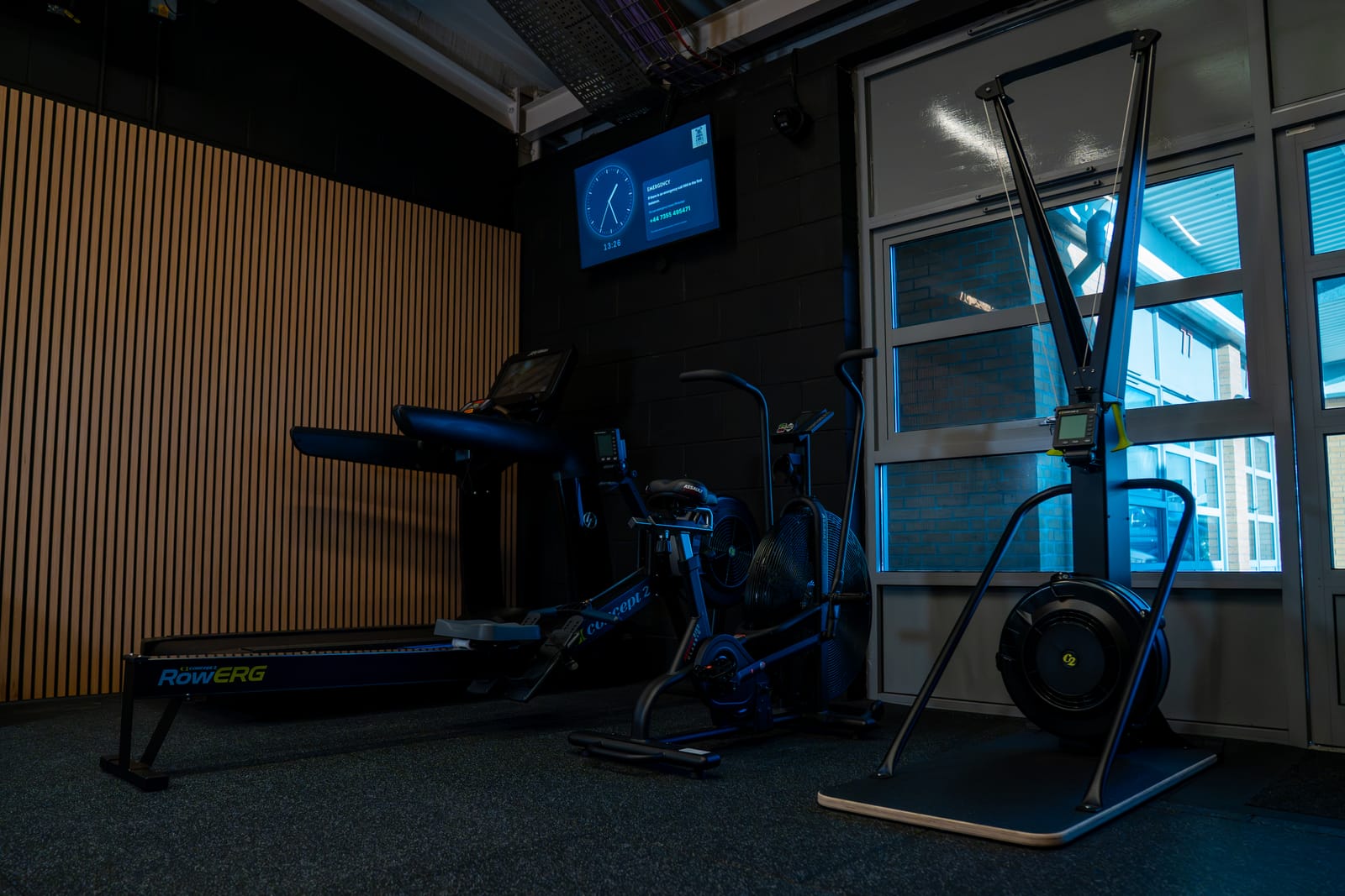 Cardio equipment including rower and bike in a calm, private setting