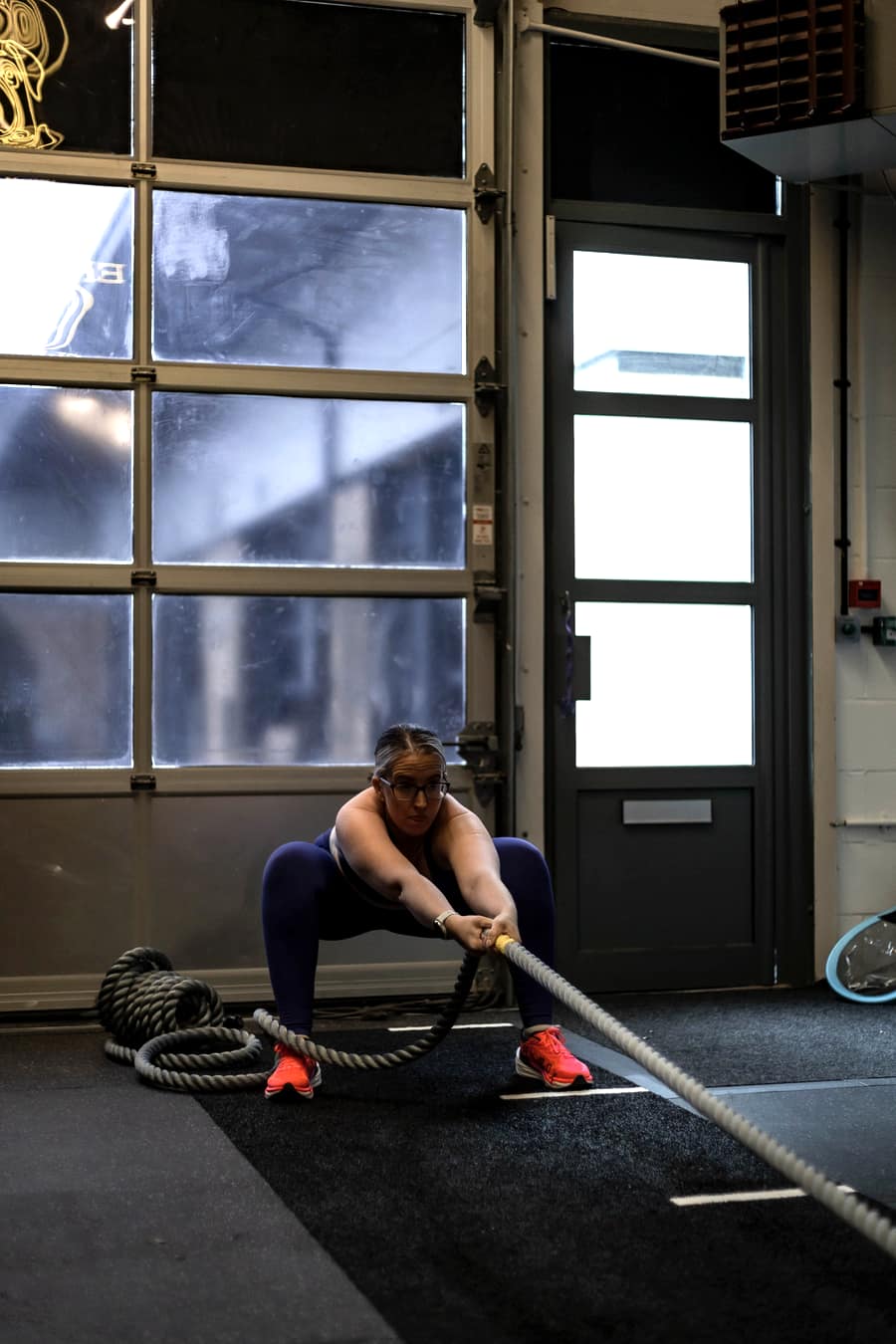 Member training with battle ropes at Effortless Gym Poole